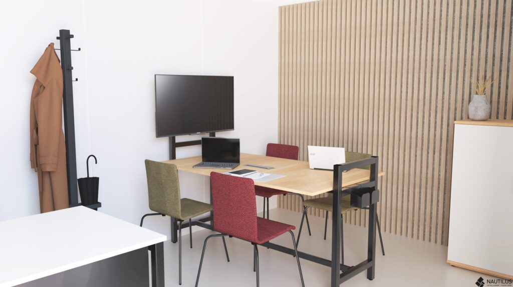 Un espace de réunion de bureau moderne avec une table en bois, quatre chaises colorées, une télévision murale, des ordinateurs portables sur la table, un porte-manteau avec un manteau marron et un parapluie, et un décor sur un meuble contre un mur à lattes.