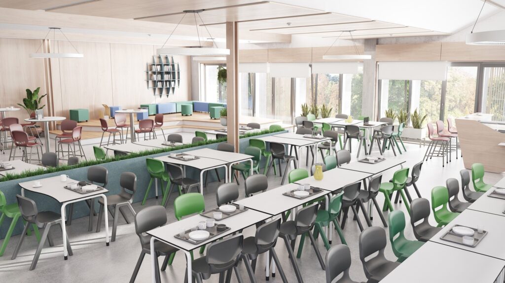 Cafétéria moderne et lumineuse avec de grandes fenêtres, des tables blanches et des chaises grises, vertes et roses. Les tables sont garnies d'assiettes et de couverts. Les plantes vertes et la lumière naturelle créent une atmosphère accueillante.