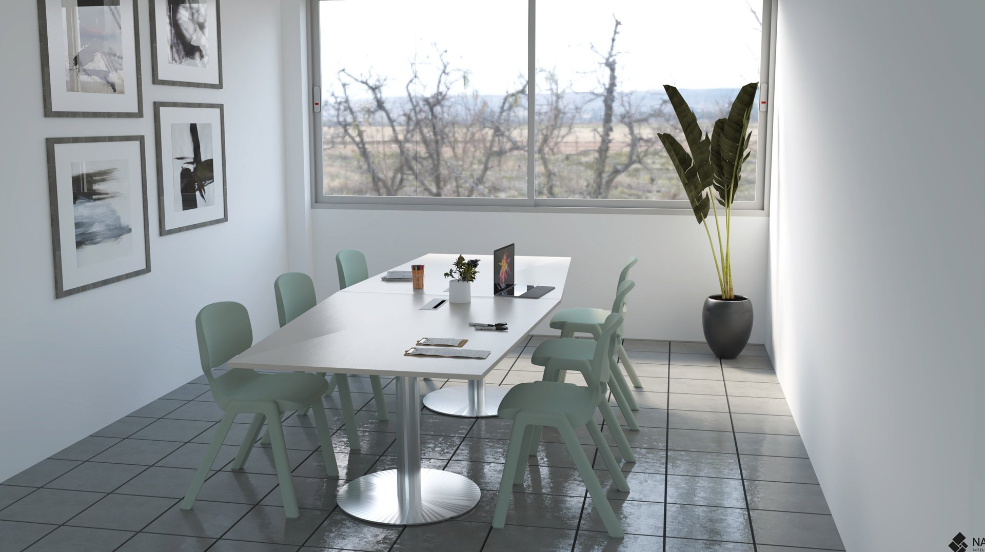 Une salle des enseignants moderne avec une longue table blanche, huit chaises vert clair, quelques ordinateurs portables et cahiers, des œuvres d'art murales, une grande fenêtre donnant sur des arbres dénudés et une grande plante en pot dans un coin.