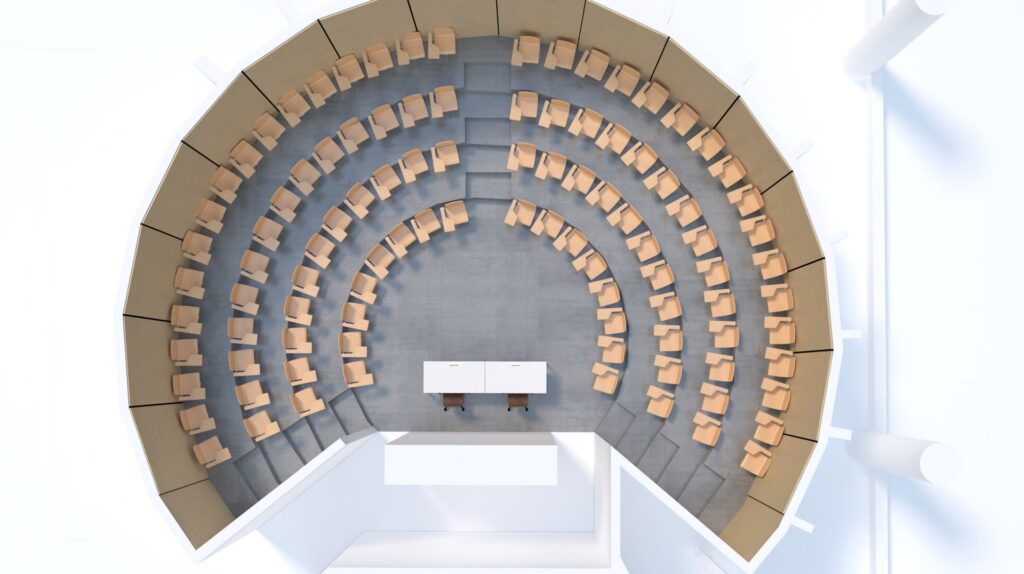 Vue aérienne d'un amphithéâtre circulaire avec cinq rangées incurvées de chaises de couleur havane faisant face à deux bureaux blancs au centre de l'avant, le tout posé sur un sol gris dans un espace moderne et lumineux.