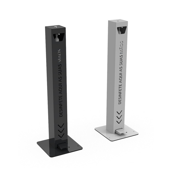 Deux distributeurs de désinfectant pour les mains autoportants, l'un noir et l'autre blanc, sont dotés d'une pédale à la base et du texte "DESINFETE AQUI AS SUAS MÃOS" sur le devant.