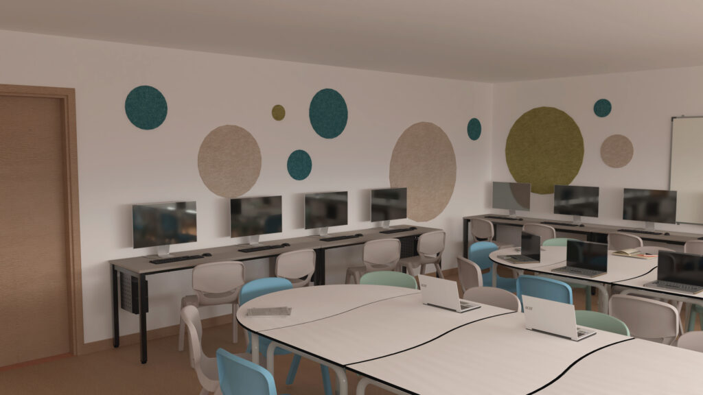 Une salle de classe moderne avec des ordinateurs le long des murs, des ordinateurs portables sur des tables blanches incurvées et des décorations murales rondes et colorées. Des chaises bleues, vertes et beiges sont disposées autour des tables.