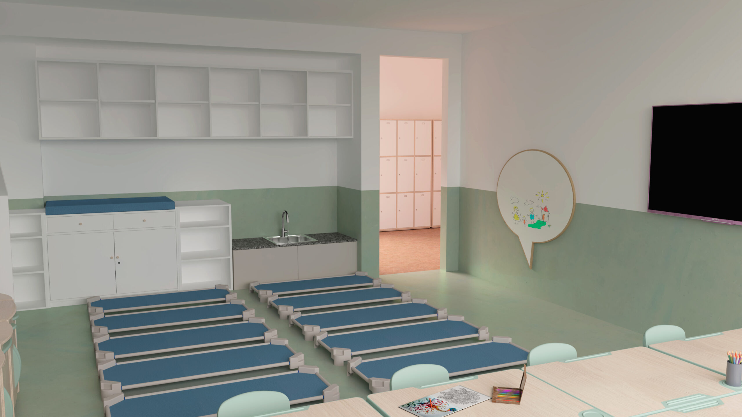 Une salle de classe avec plusieurs lits bleus disposés en rangées, un petit évier et des armoires, des casiers visibles par une porte ouverte, un tableau blanc rond avec des dessins, et une table avec des livres et des fournitures au premier plan.